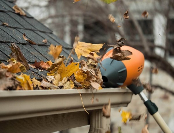 Blowing Leaves out of Gutter Pipe