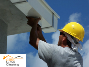 Gutter technician performing gutter repairs.